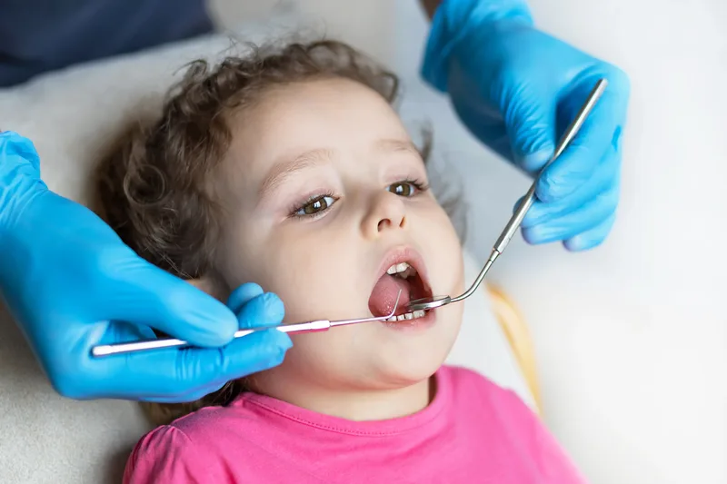 A child receiving protective dental sealants during a checkup